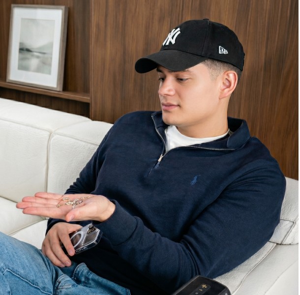 Tom, founder of TeeTee&Co, holding diamond jewelry